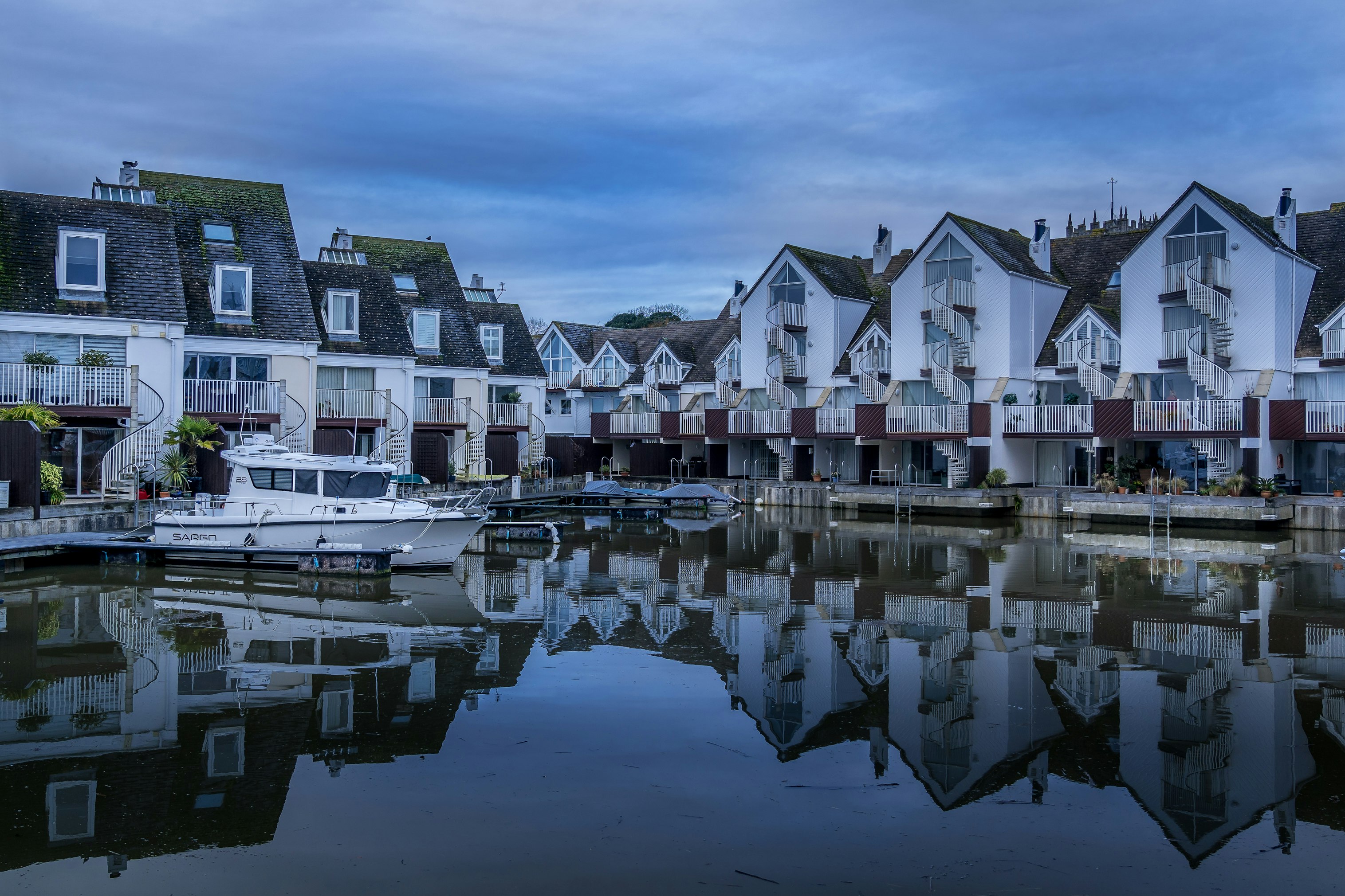 white and brown houses near body of water during daytime